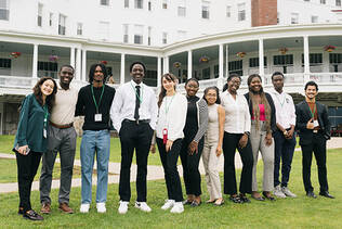 Group photo of POWERED participants standing outside in front of a building