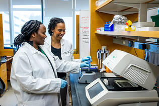 A provider works with a student in a lab