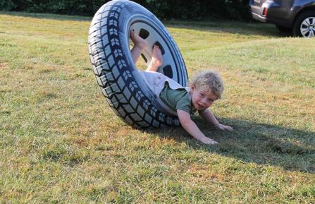 Ryland Stout playing with a tire.