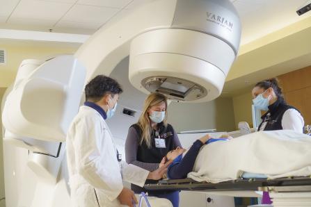 Using the high-precision TrueBeam® radiotherapy system, radiation therapists assist a patient.
