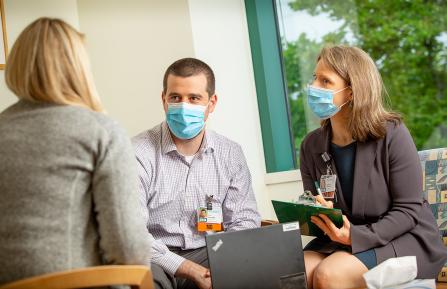 caregivers talking to a patient