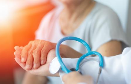 photo of doctor holding patient's hand