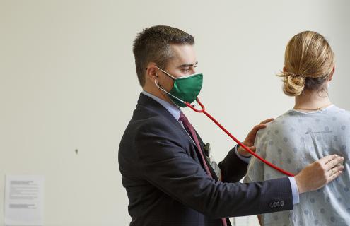 Simon Khagi, MD, examining a patient.