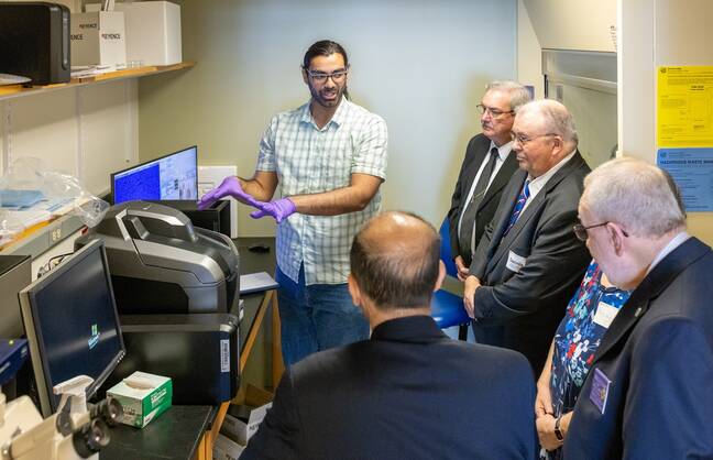 Philanthopists visiting cancer immunology research lab.